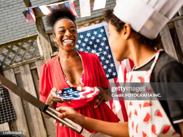 joven chef anf su madre en la barbacoa del 4 de julio - 4th of july cookout fotografías e imágenes de stock