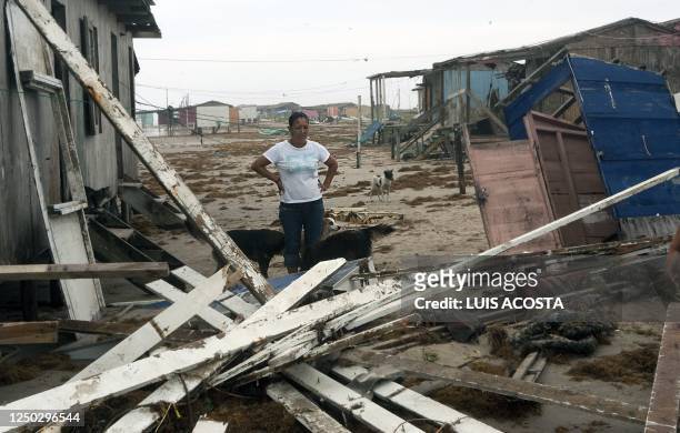 Woman stares at her damaged house after the passage of Hurricane Alex in Bagdad Beach, in Matamoros, Tamaulipas State, on July 1, 2010. Alex, the...