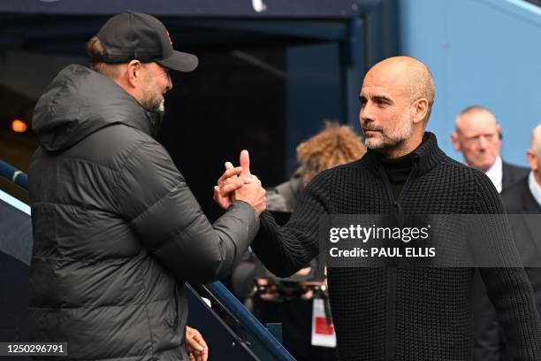 Liverpool's German manager Jurgen Klopp and Manchester City's Spanish manager Pep Guardiola shake hands ahead of kick-off in the English Premier...