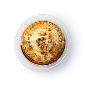 Hummus with pine nuts in the bowl isolated with shadow on white background