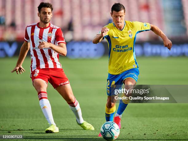 Ivan Martos of UD Almeria competes for the ball with Slavoljub Srnic of Las Palmas during the La Liga Smartbank match between UD Almeria and UD Las...