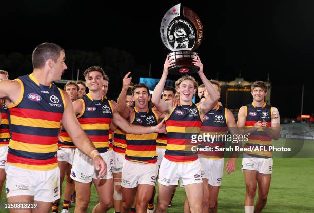 Max Michalanney of the Crows holds up the Showdown trophy as the team walks off after the win /during the 2023 AFL Round 03 match between the Port...