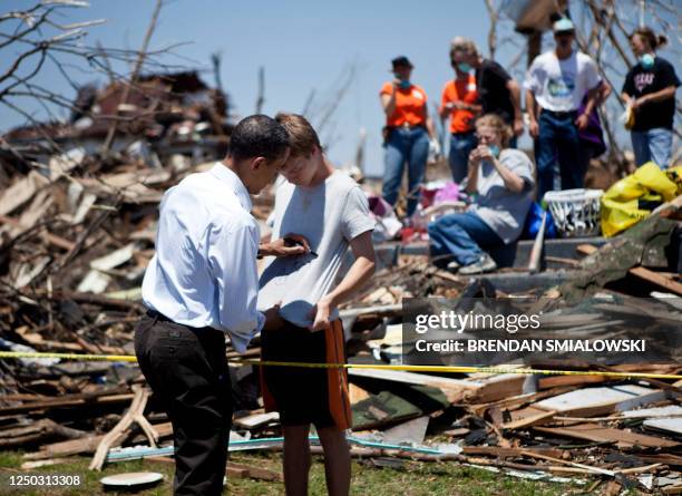 President Barack Obama signs a boy's T-shirt in tornado-damaged Joplin, Missouri on May 29, 2011. Victims of the tornado continue to recover as 2011...