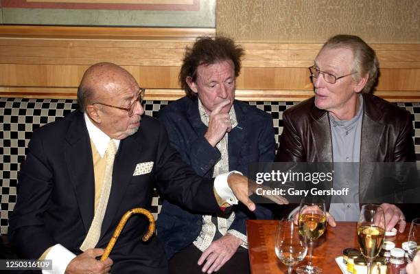 View of Atlantic Records President and co-founder Ahmet Ertegun and Rock musicians Jack Bruce and Ginger Baker as they talk during an after-party at...