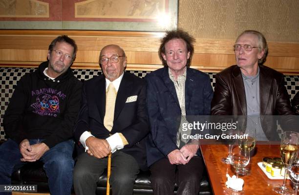 Portrait of Atlantic Records President and co-founder Ahmet Ertegun as he sits with the members of the Rock group Cream, Eric Clapton , Jack Bruce ,...