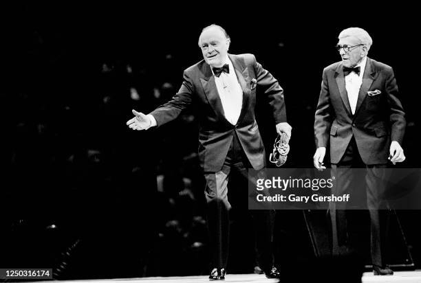 British-born American actor and comedian Bob Hope and American comedian George Burns perform onstage at Madison Square Garden, New York, New York,...