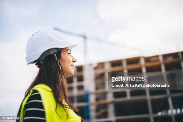 portrait of woman architect on construction site. - engineer stock pictures, royalty-free photos & images