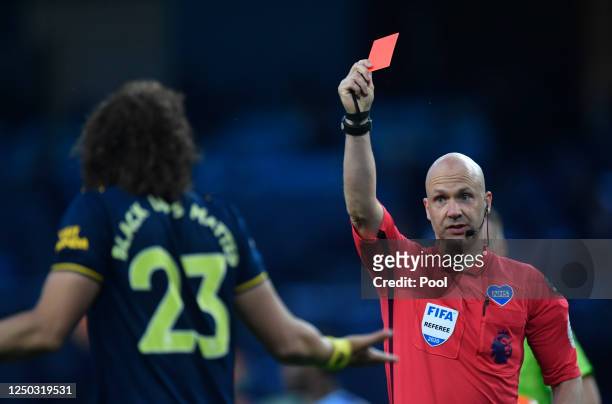 David Luiz of Arsenal receives a red card from match referee Anthony Taylor during the Premier League match between Manchester City and Arsenal FC at...