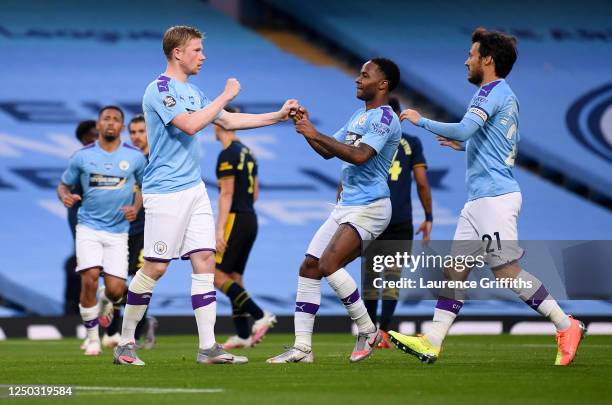 Kevin De Bruyne of Manchester City celebrates with teammates Raheem Sterling and David Silva after scoring his team's second goal during the Premier...
