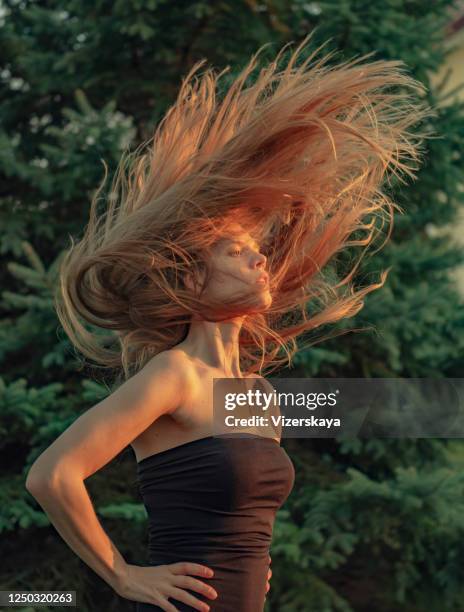 flying hair in nature - woman little black dress stock pictures, royalty-free photos & images