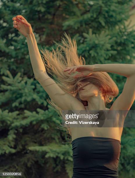 flying hair in nature - woman little black dress stock pictures, royalty-free photos & images
