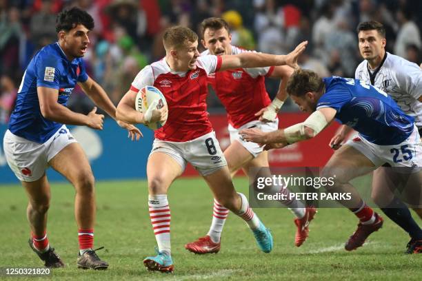 Great Britains Freddie Roddick is tackled by Frances Thibaud Mazzoleni on the second day of the Hong Kong Sevens rugby tournament on April 1, 2023.