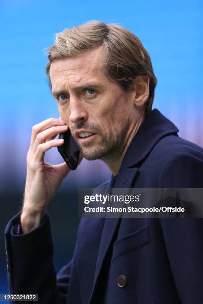 Sport analyst Peter Crouch speaking on his phone during the Premier League match between Manchester City and Liverpool FC at Etihad Stadium on April...