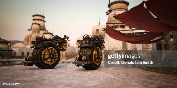 futuristic desert city with monowheel industrial tractors - monowheel stockfoto's en -beelden