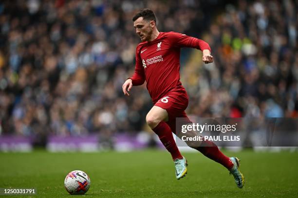 Liverpool's Scottish defender Andrew Robertson runs with the ball during the English Premier League football match between Manchester City and...