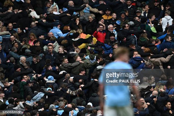 Manchester City's fans do their Poznan celebration after Manchester City's English midfielder Jack Grealish scores their fourth goal during the...