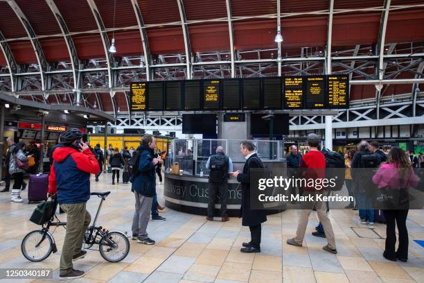 Commuters view a live departure board at Paddington rail station showing delayed and cancelled trains on 13 March 2023 in London, United Kingdom....