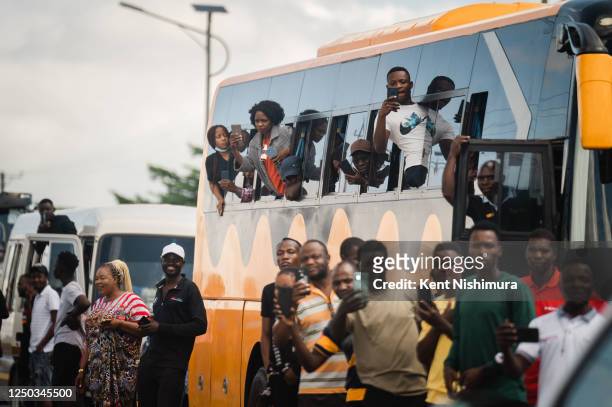 People line the streets as Vice President Kamala Harriss motorcade passes by on the way to Panuka Farm on Saturday, April 1, 2023 in Lusaka, Zambia....