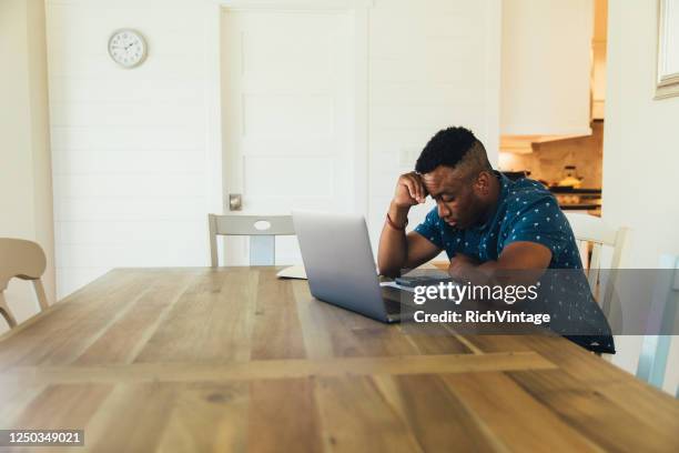 worried man doing finances at home - job search stress stock pictures, royalty-free photos & images