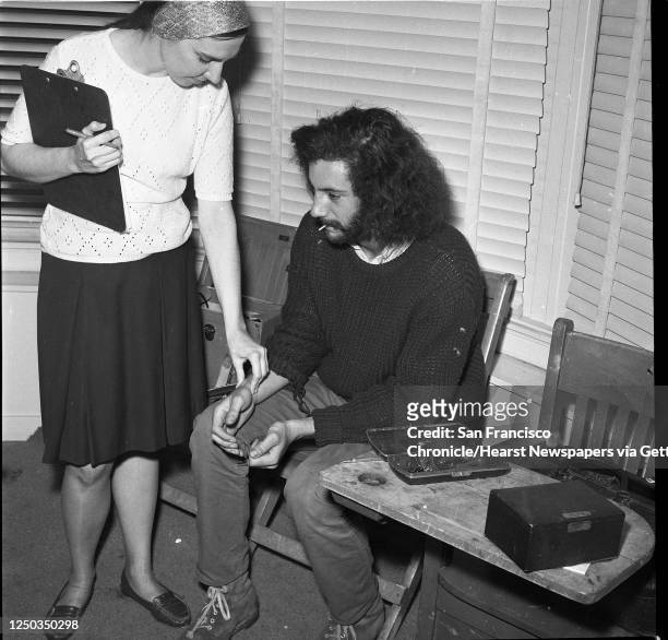 Patient Bill Stabile has his pulse checked by nurse Carmella Ranelli before he is seen by Dr. Lawrence Rose at the Free Clinic for Hippies at the...
