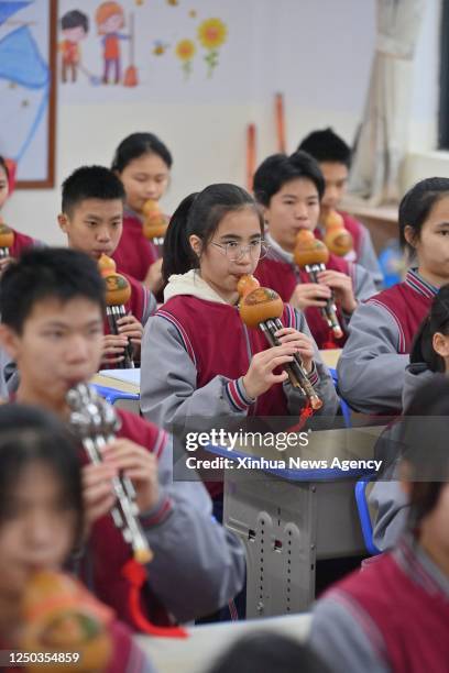 Students play the cucurbit flute at a middle school in Cangwu County of Wuzhou City, south China's Guangxi Zhuang Autonomous Region, March 29, 2023....