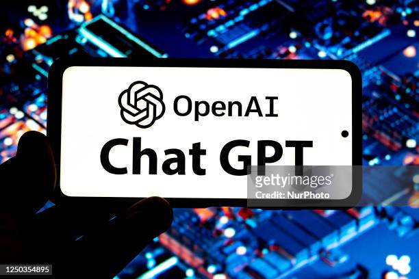 Photo illustration showing ChatGPT and OpenAI research laboratory logo and inscription at a mobile phone smartphone screen with a blurry background....