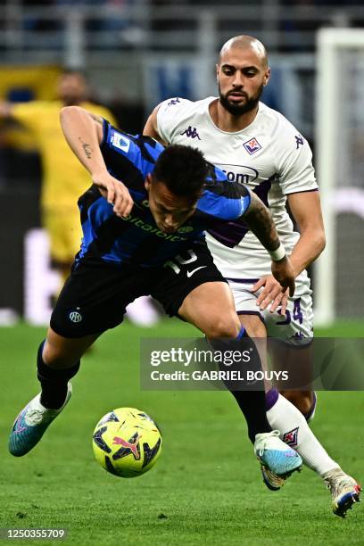 Inter Milan's Argentinian forward Lautaro Martinez outruns Fiorentina's Moroccan midfielder Sofyan Amrabat during the Italian Serie A football match...