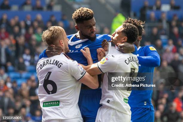 Harry Darling and Ben Cabango of Swansea City and Cedric Kipre of Cardiff City scuffle during the Sky Bet Championship match between Cardiff City and...