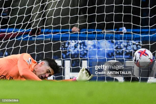 Chelsea's Spanish goalkeeper Kepa Arrizabalaga fails to stop Aston Villa's second goal scored by Aston Villa's Scottish midfielder John McGinn during...