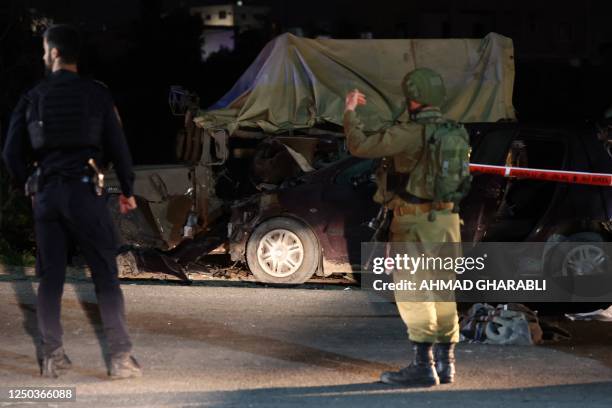 Israeli soldiers gather at the site of a ramming attack near the town of Beit Ummar, north of Hebron city in the occupied West Bank, on April 1, 2023.