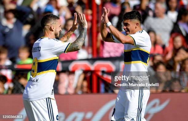 Dario Benedetto and Luca Langoni of Boca Juniors celebrate after their team's first goal scored by an own goal from Agustin Dattola of Barracas...