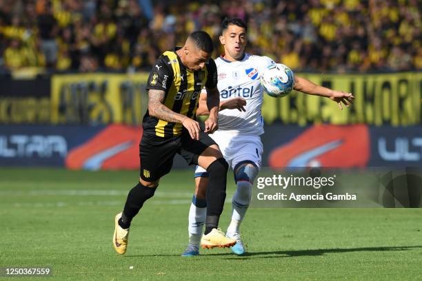 Kevin Mendez of Peñarol and Diego Rodríguez of Nacional fight for the ball during the Torneo Apertura 2023 match between Peñarol and Nacional at...