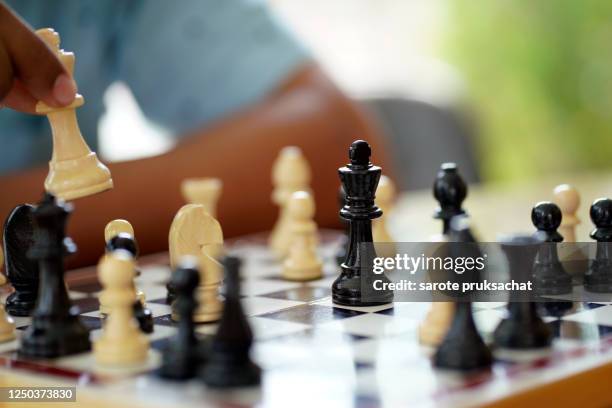 close-up businessman playing chess . - king chess piece stock-fotos und bilder