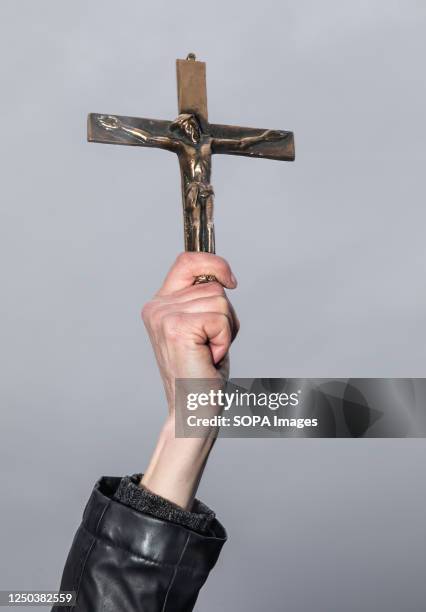 Protester holds a golden crucifix in his hand. The Ukrainian Orthodox Church of the Moscow Patriarchate which has been ordered to vacate the premises...