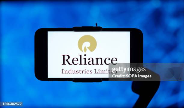 In this photo illustration, the Reliance industries logo is seen displayed on a mobile phone screen.