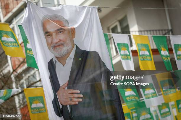 Kurdish Islamist Free Cause Party small flags hanging on a street in Ankara and a large cloth flag with the photo of Party Chairman Zekeriya Yapcolu....