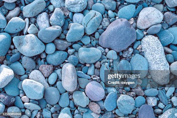 abstract dry pebbles stones blue toned background - cobblestone texture stock pictures, royalty-free photos & images