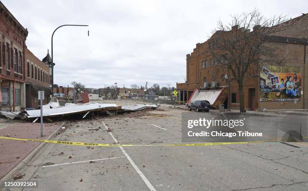 The marquee sign above the entrance to the Apollo Theatre, right, is collapsed onto the street and a portion of a roof lies across the street...