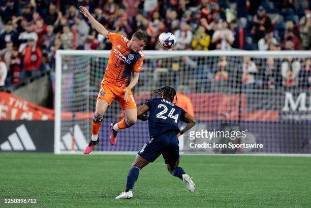New York City FC midfielder Matias Pellegrini heads the ball over New England Revolution midfielder DeJuan Jones during a match between the New...