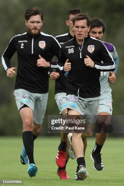 Neil Kilkenny leads Alex Grant, Bruno Fornaroli and Tomislav Mrcela while running during a Perth Glory A-League training session at UWA Sports Park...