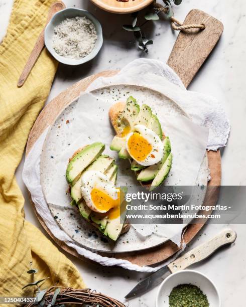 avocado and egg toasts - toasted bread stock pictures, royalty-free photos & images