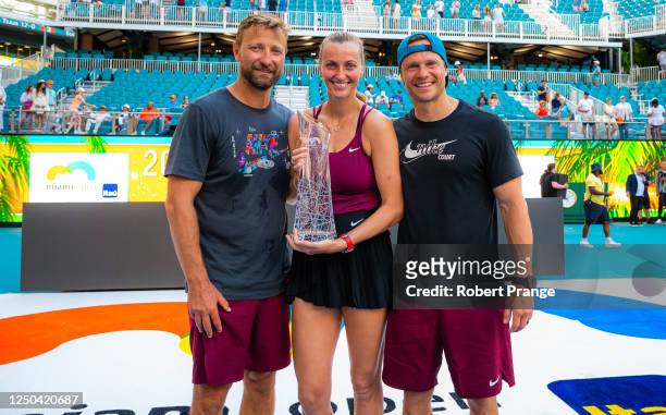 Petra Kvitova of the Czech Republic poses with coach and fiance Jiri Vanek and fitness trainer Zdenek Kompanek after defeating Elena Rybakina of...