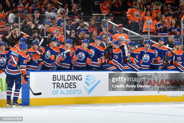 Leon Draisaitl of the Edmonton Oilers celebrates after his second goal of the second period against the Anaheim Ducks with his teammates at the bench...