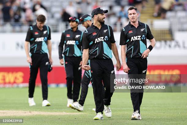 New Zealand's Daryl Mitchell Adam Milne leave the field after defeat in the super over of the first Twenty 20 international cricket match between New...