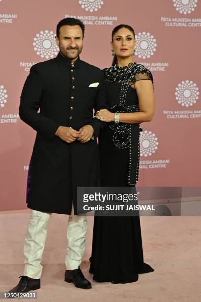 In this picture taken on April 1 Bollywood actors Saif Ali Khan and Kareena Kapoor poses for pictures during the inauguration of the Nita Mukesh...