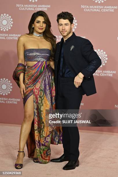 In this picture taken on April 1 actress Priyanka Chopra Jonas with US singer-songwriter Nick Jonas poses for pictures during the inauguration of the...