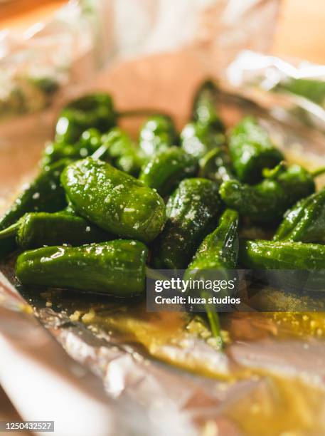 preparing pimientos de padron with salt and olive oil - olive pimento stock pictures, royalty-free photos & images