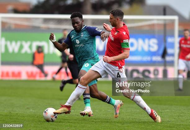 Mike Fondop of Oldham Athletic Association Football Club tussles with Ben Tozer of Wrexham Football Club during the Vanarama National League match...
