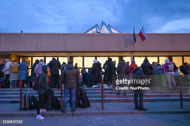 Ukrainians queue up for passport control before boarding the evening train from Przemysl to Ukraine., on March 30 in Przemysl, Poland. Refugees from...