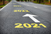 Number of 2021 to 2024 on asphalt road surface with white arrow